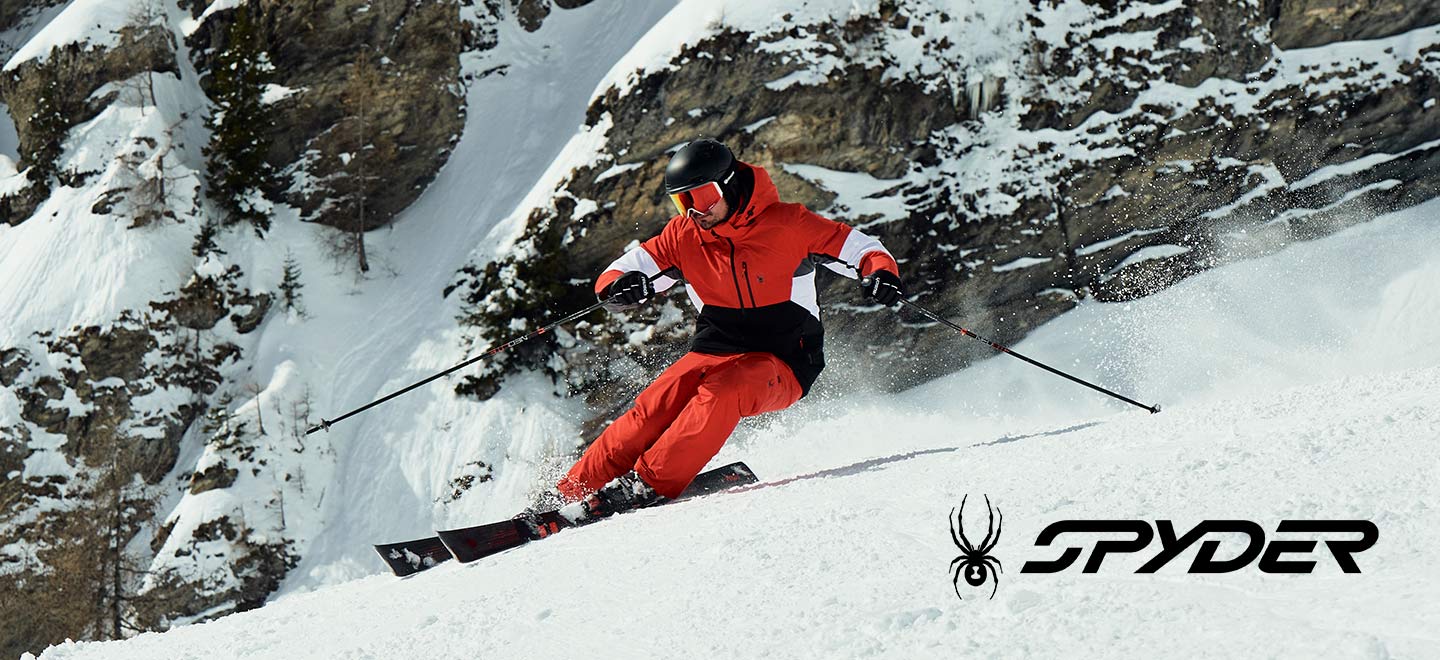 skier skiing downhill wearing spyder skiwear